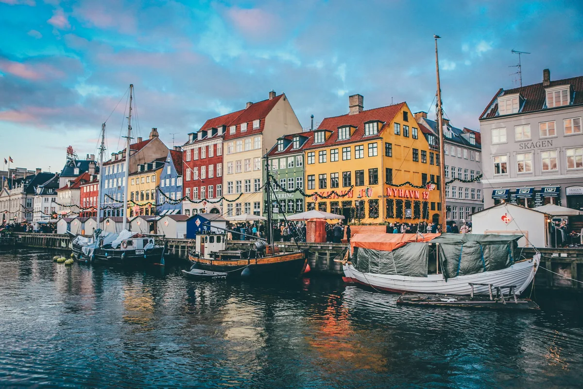 Boats and colourful townhouses along the Nyhavn canal in Copenhagen, a short walk from Kongens Nytorv
