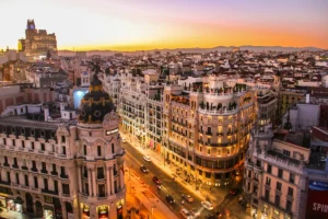 Gran Vía and the Metropolis building in Madrid at sunset