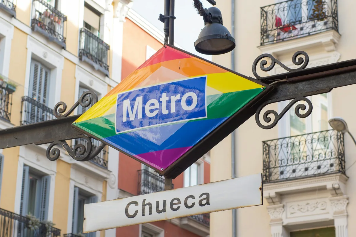The rainbow Metro sign at Chueca station on Plaza de Chueca, Madrid