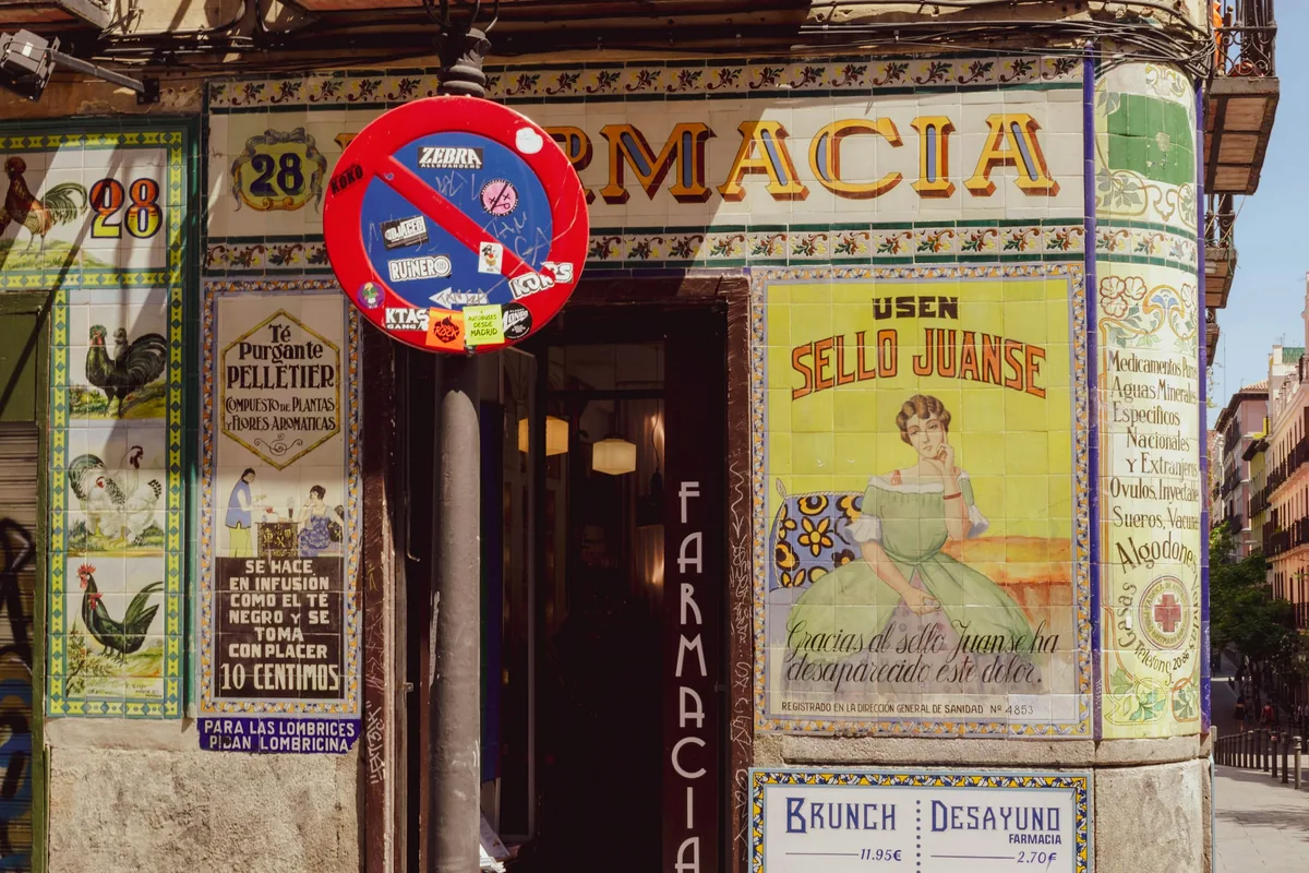 The tiled facade of the old Juanse pharmacy on Calle de San Vicente Ferrer in Malasaña, Madrid