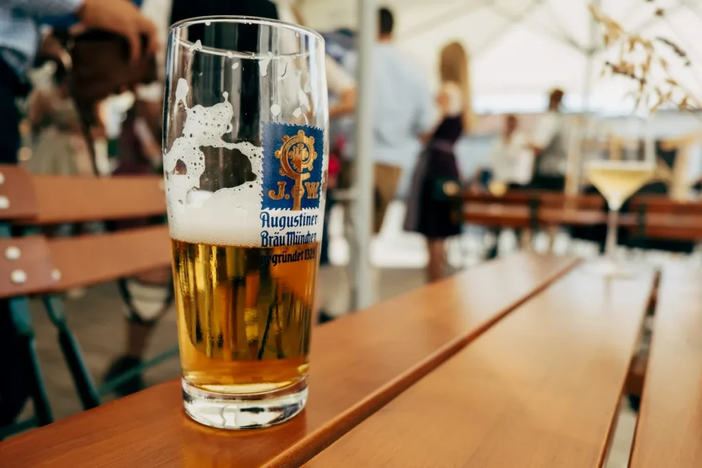 A glass of Augustiner beer on a table in a Munich beer garden