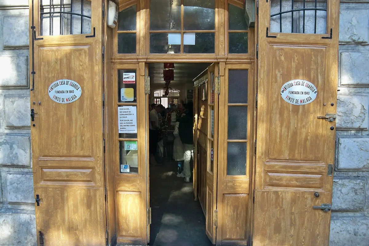Wooden entrance doors of Antigua Casa de Guardia, the historic wine bodega in Malaga