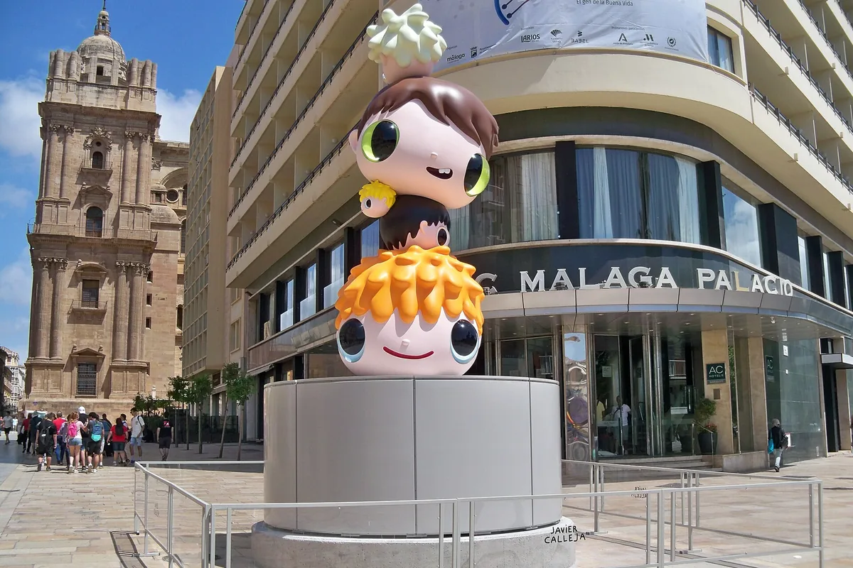 Entrance of AC Hotel Málaga Palacio, home of the ÀTICO rooftop bar, with the cathedral tower behind