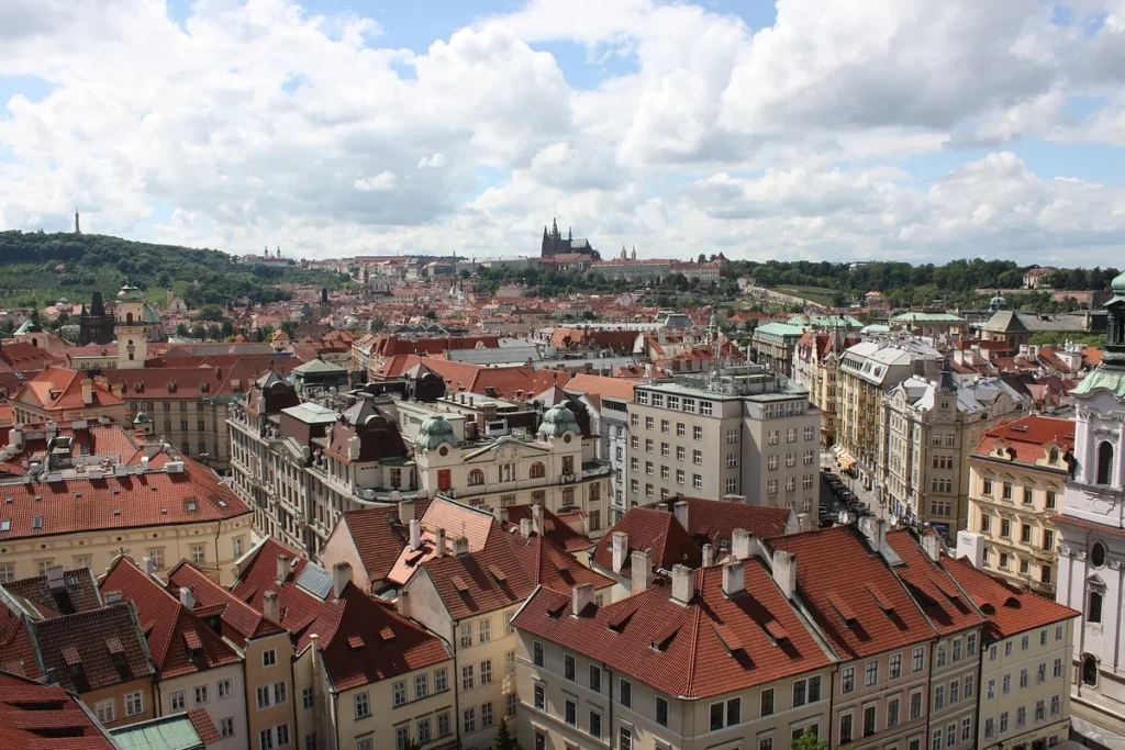 Red rooftops of Prague Old Town with Prague Castle in the distance