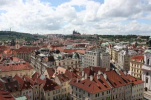 Red rooftops of Prague Old Town with Prague Castle in the distance