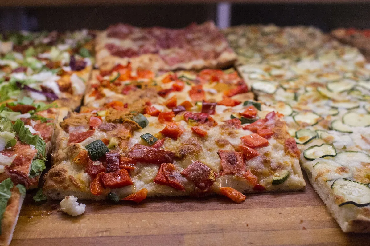 Trays of pizza al taglio sold by the slice in Rome