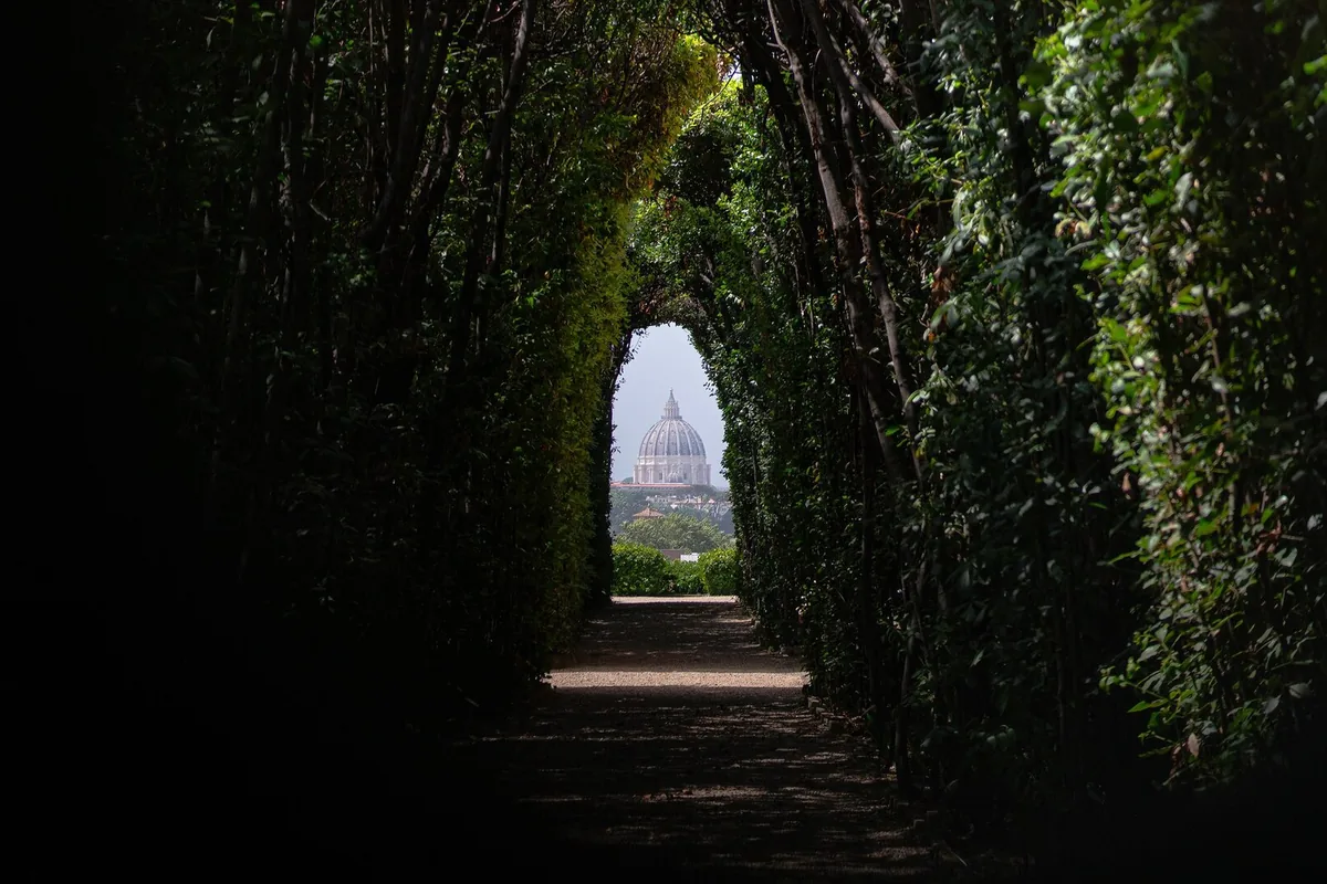 The dome of St Peter's framed by the hedges, seen through the Aventine keyhole, Rome
