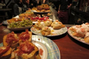 A bar counter piled with pintxos in San Sebastián