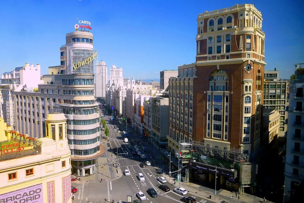 Gran Via in Madrid seen from a rooftop, with the Edificio Carrión and Schweppes sign