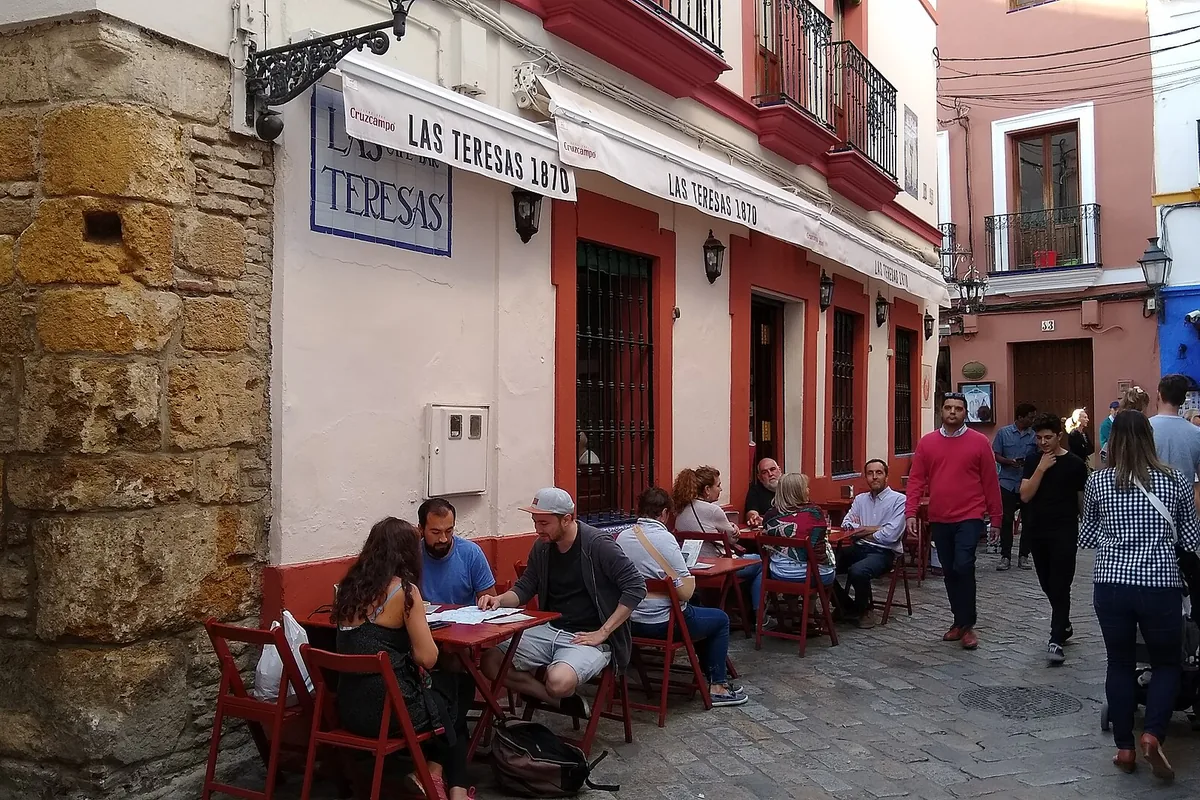 The corner exterior and sign of Bar Las Teresas in Santa Cruz, Seville
