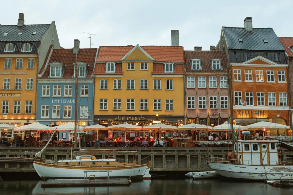 Cafe umbrellas and colourful townhouses along the Nyhavn canal in Copenhagen