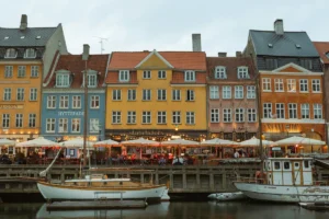 Cafe umbrellas and colourful townhouses along the Nyhavn canal in Copenhagen