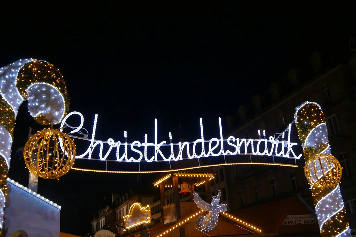 Illuminated Christkindelsmärik sign at the Strasbourg Christmas market at night