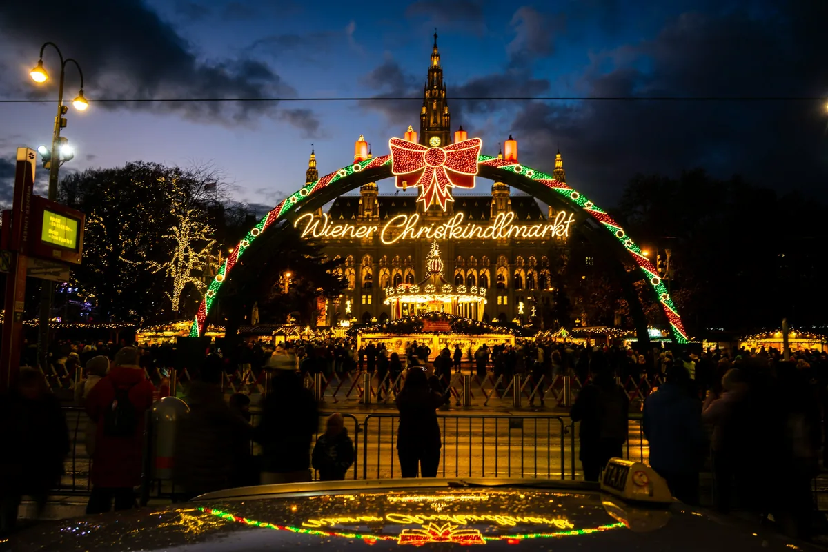 Lit entrance arch of the Wiener Christkindlmarkt in front of Vienna City Hall