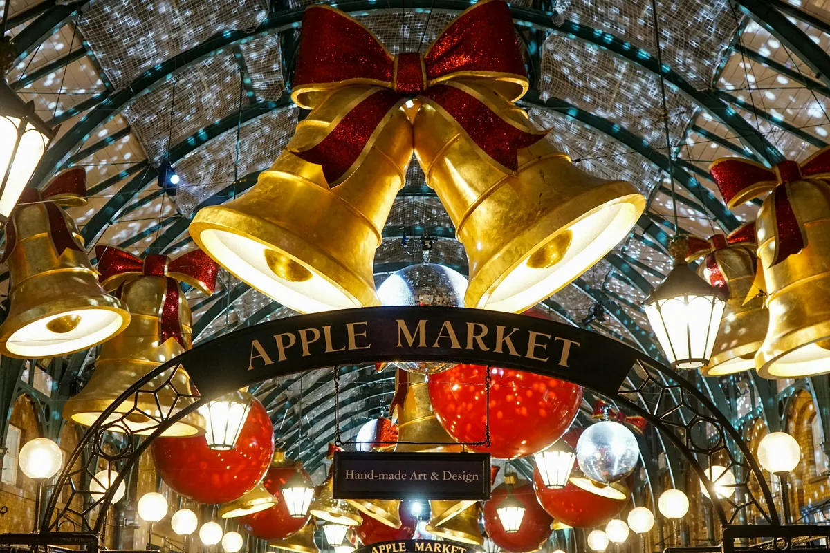 Giant golden Christmas bells and baubles above the Apple Market in Covent Garden