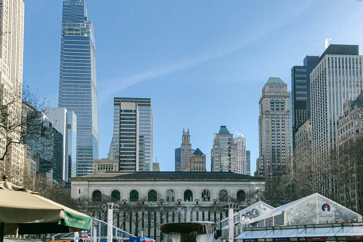 Bryant Park Winter Village kiosks beside the New York Public Library