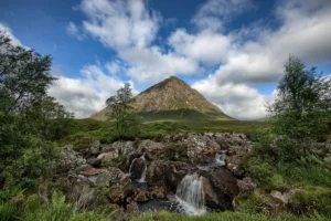 Buachaille Etive Mòr rising above a waterfall at the eastern end of Glencoe, Scotland