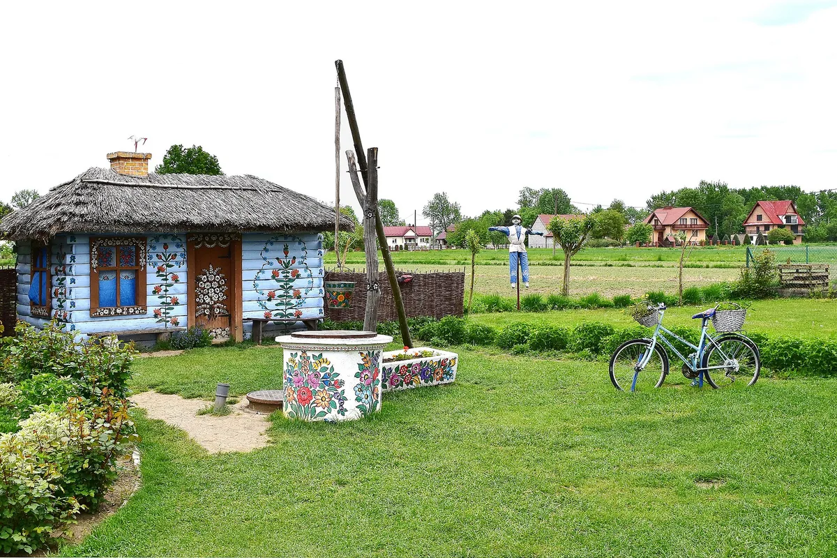 Painted thatched cottage and well in the village of Zalipie