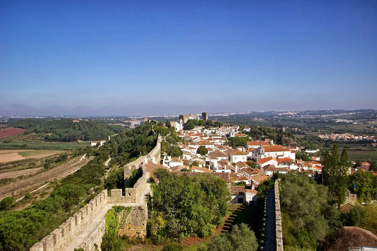The medieval town walls and rooftops of Óbidos, Portugal