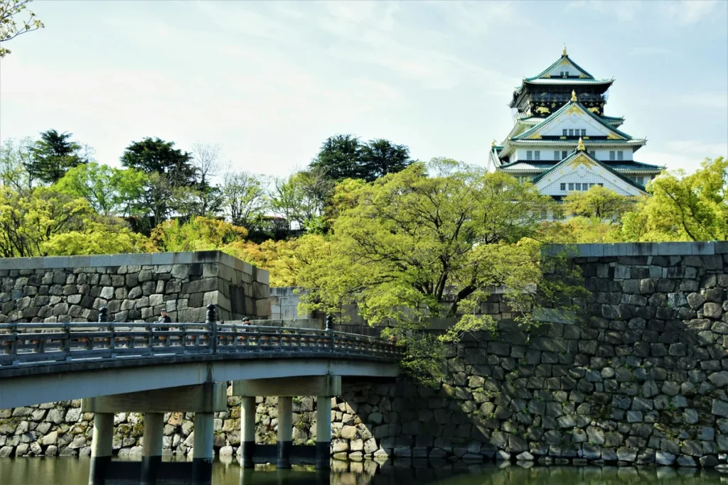 Osaka Castle rising above its moat and stone walls in Osaka, Japan