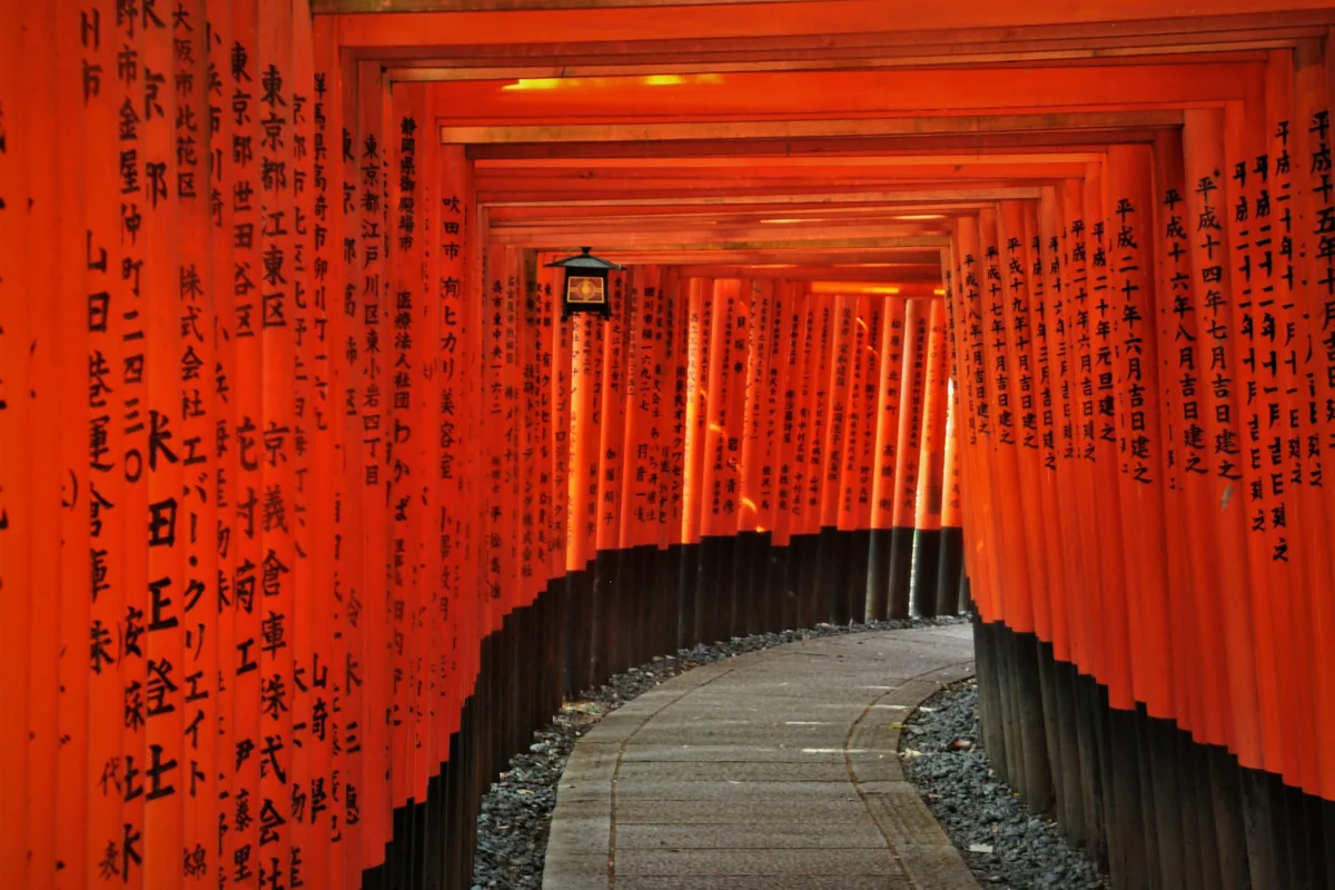 Tunnel of red torii gates at Fushimi Inari shrine in Kyoto, Japan