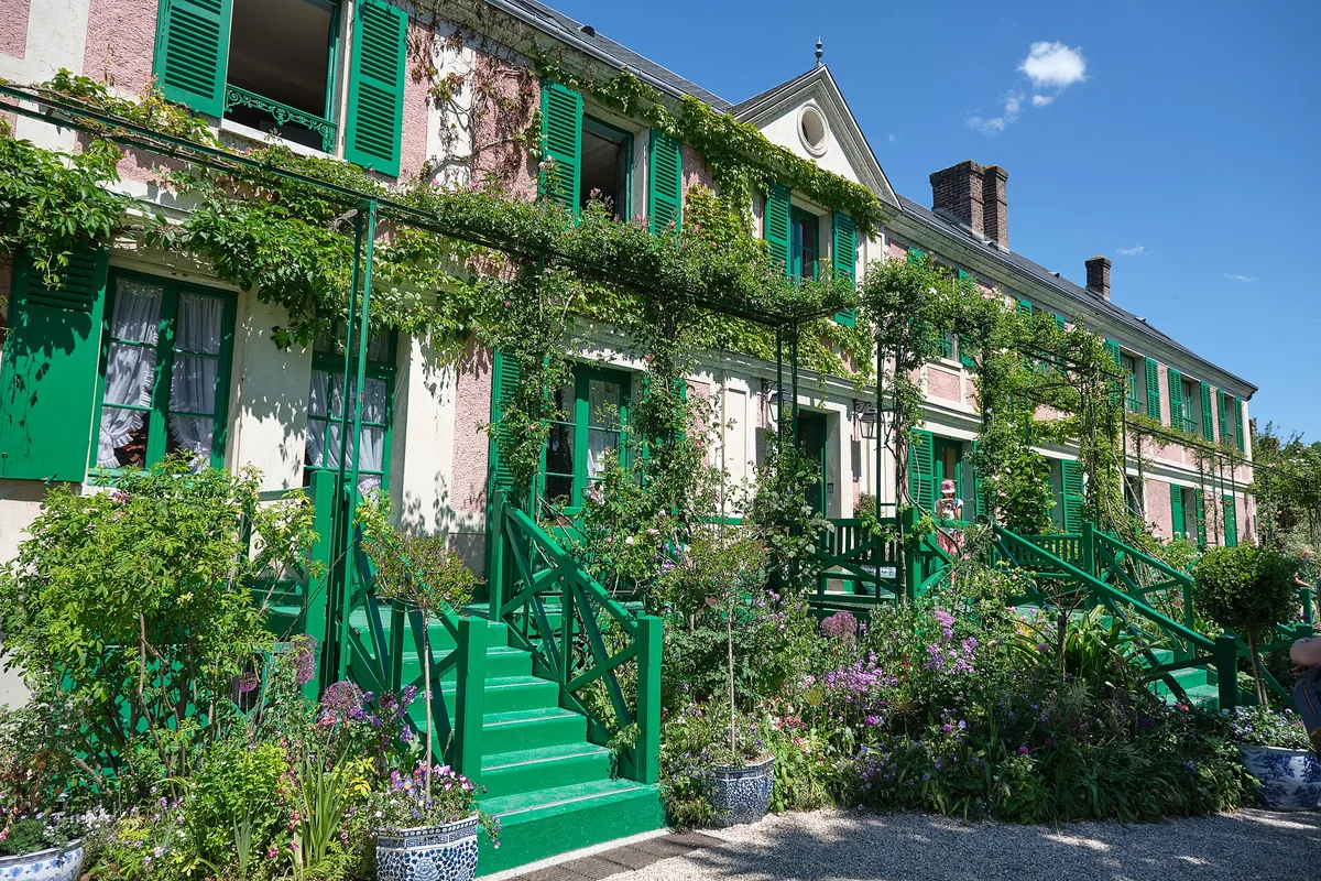 Claude Monet's pink house with green shutters and steps at Giverny