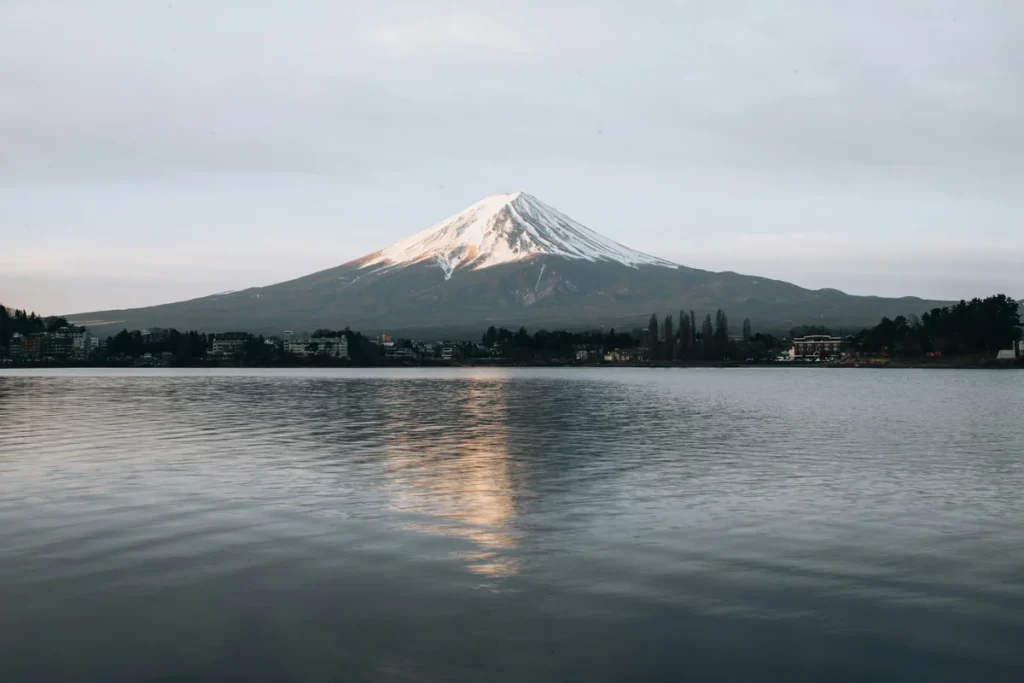 Snow-capped Mount Fuji reflected in a calm lake, a classic day trip from Tokyo