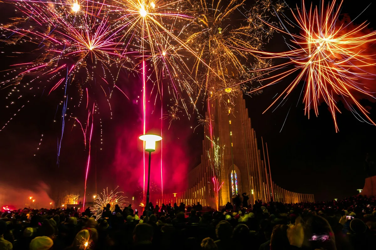 Crowds watching fireworks around Hallgrímskirkja church in Reykjavik
