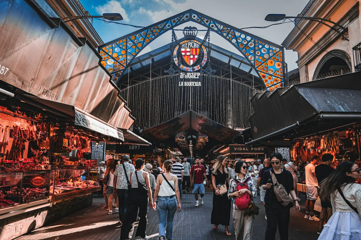 Market stalls beneath the entrance of Mercat de la Boqueria, Barcelona