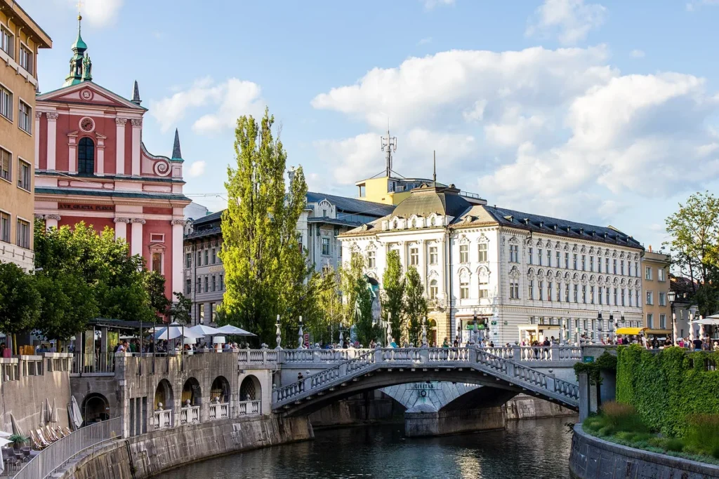 The Triple Bridge and the pink Franciscan Church beside the Ljubljanica river in Ljubljana