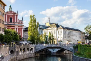 The Triple Bridge and the pink Franciscan Church beside the Ljubljanica river in Ljubljana