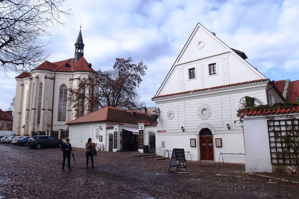 The white gabled building of the Strahov Monastery Brewery beside the Church of St Roch in the Strahov Monastery courtyard, Prague