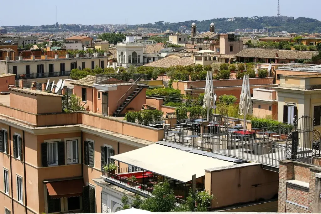 Rooftop terraces with umbrellas above the roofs of Rome