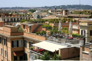 Rooftop terraces with umbrellas above the roofs of Rome
