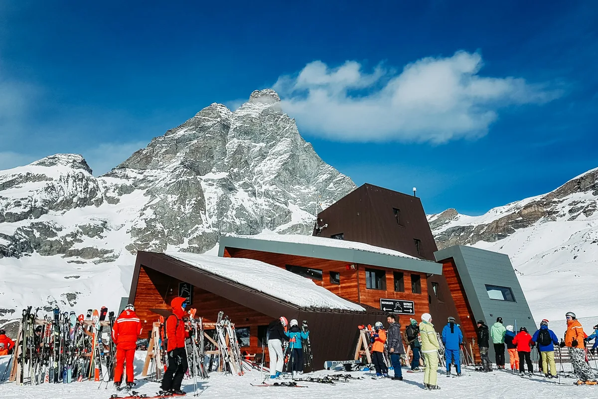 Skiers on the slopes of Cervinia below the Matterhorn