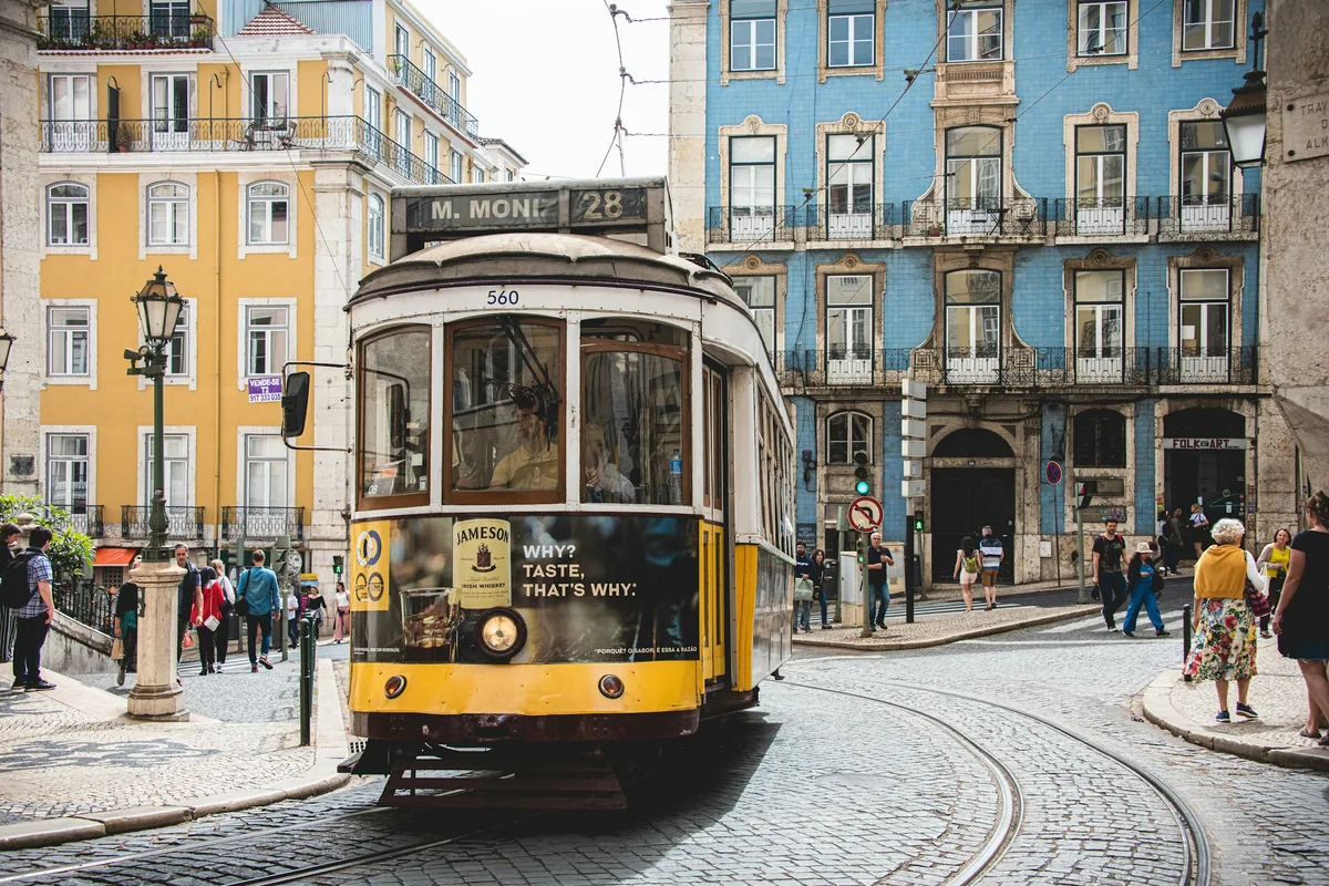 Yellow Tram 28 to Martim Moniz on a cobbled street in Lisbon