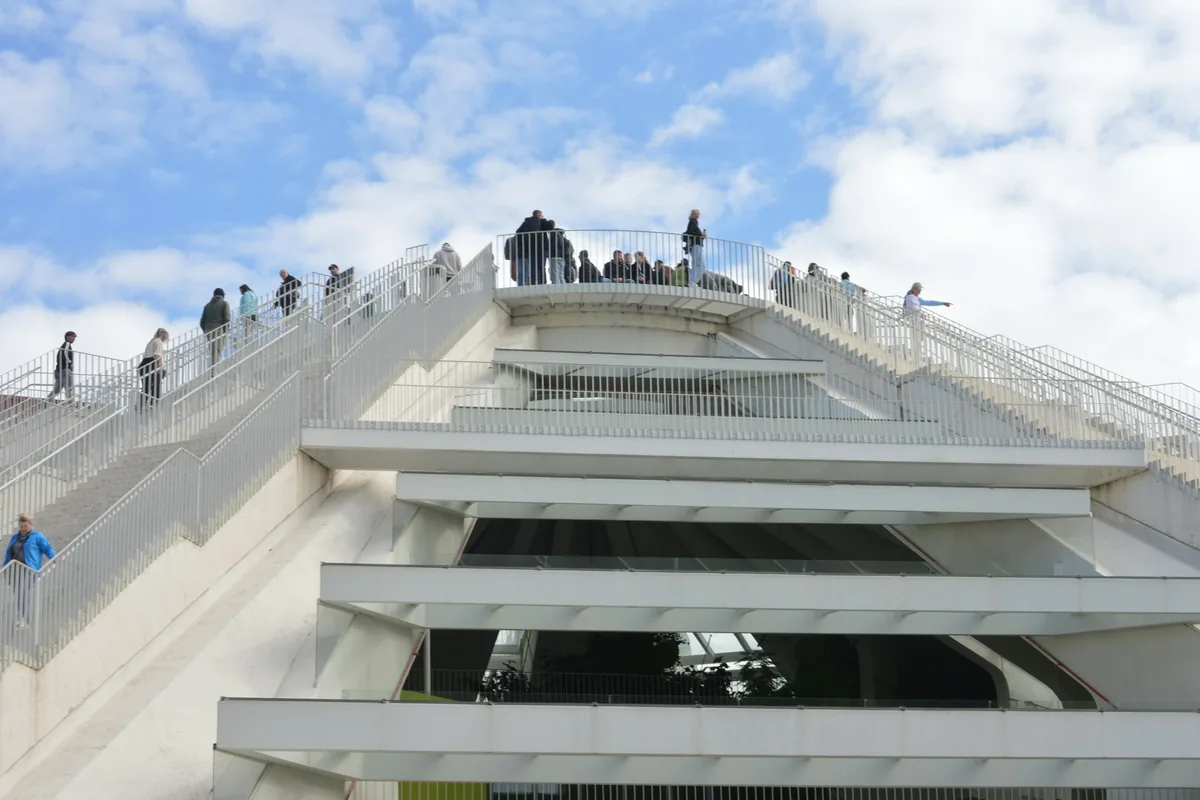 Visitors climbing the steps on the outside of the Pyramid of Tirana
