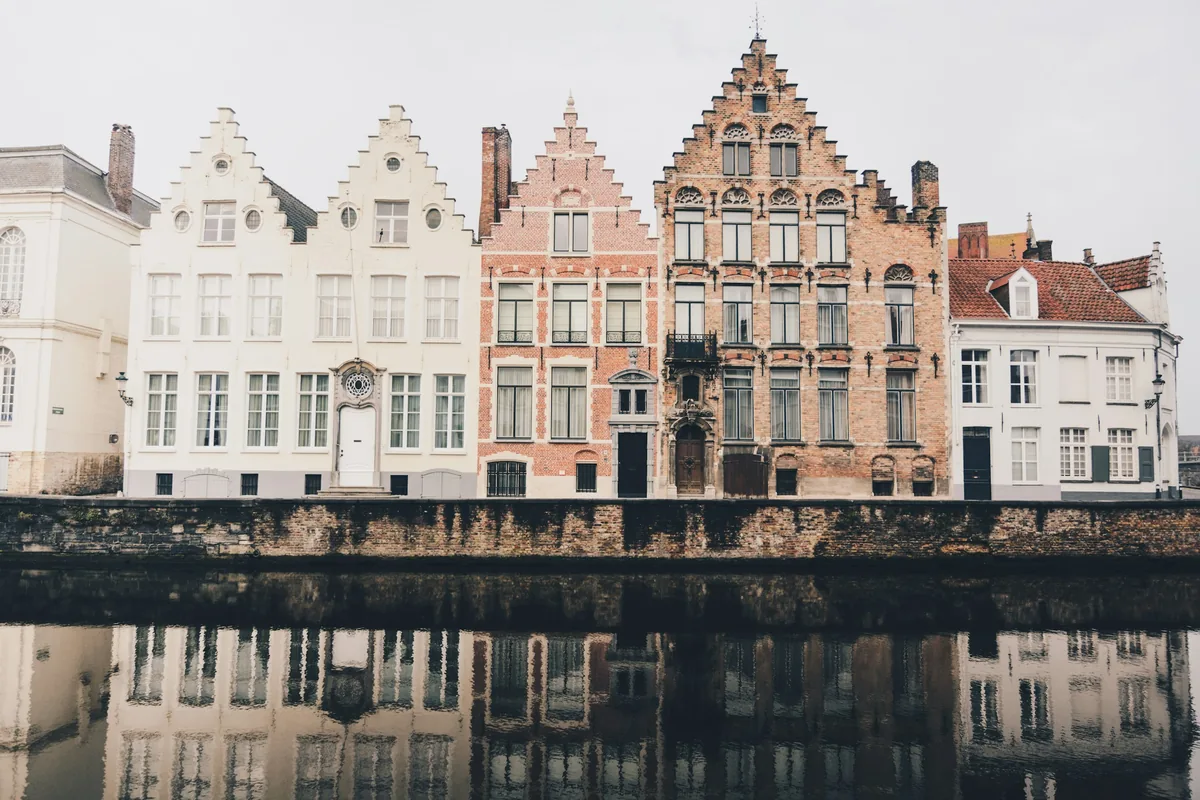 Gabled houses reflected in a canal in Bruges