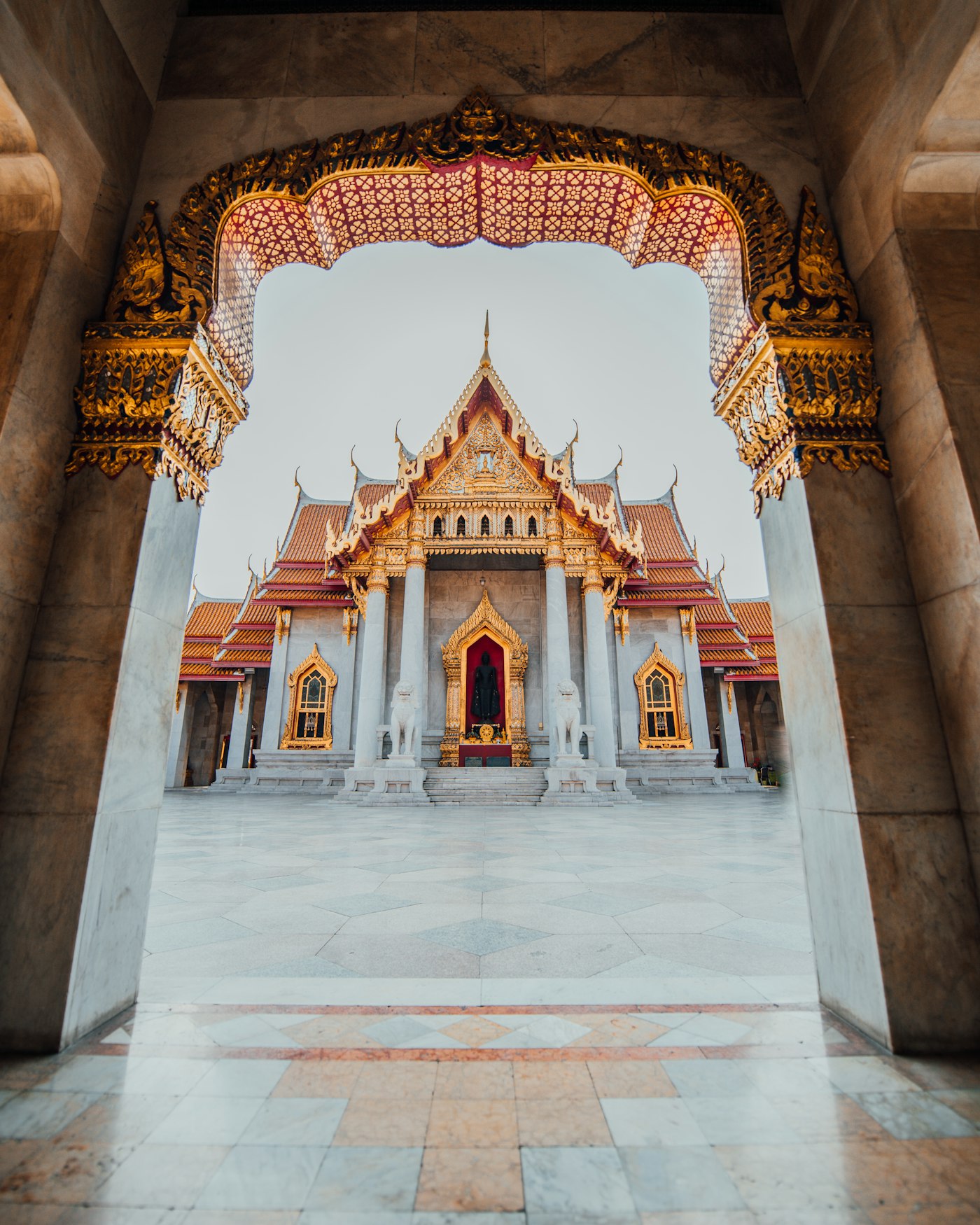 Wat Benchamabophit, the Marble Temple in Bangkok, framed by a carved archway